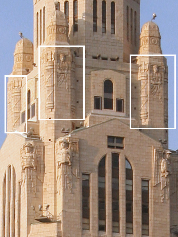 The upper stories of the Leveque Tower in Columbus, Ohio, with large fasces carved into the stone.